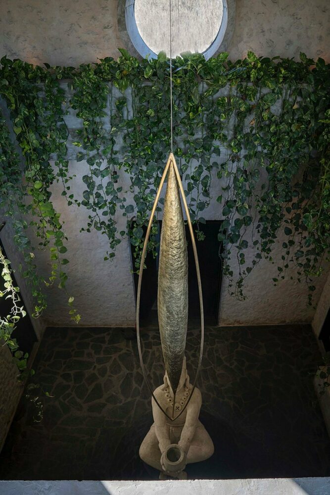 a bronze 'metate hand' sculpture by Luciano Matus suspends in the double-height space