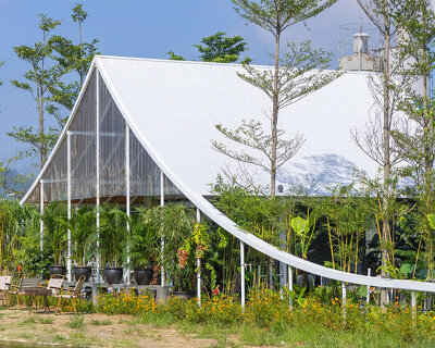 nguyen khac phuoc architects crowns its ká coffee in vietnam with a sweeping white canopy