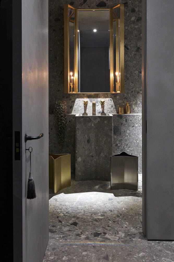 lower level powder room echoing Gio Ponti faucets