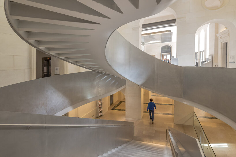 monumental staircase meanders within national library of france, captured by danica o. kus