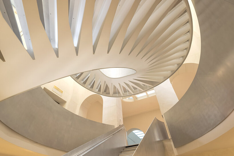 monumental staircase meanders within national library of france, captured by danica o. kus