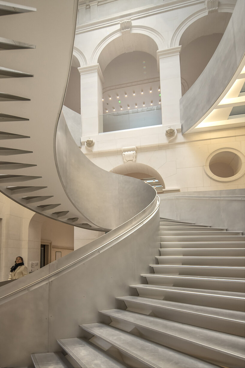 monumental staircase meanders within national library of france, captured by danica o. kus