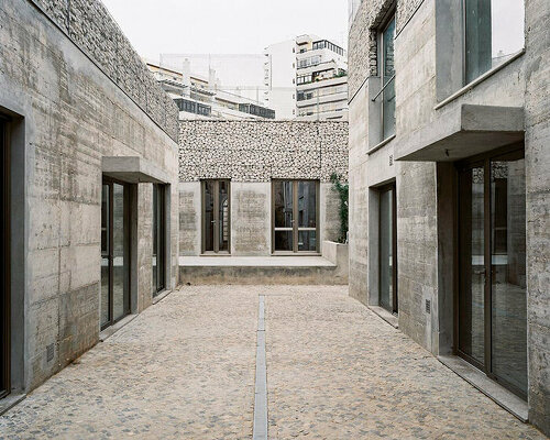 corpo atelier unveils three exposed concrete and stone facades in portugal