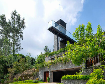 steel frame supports stone-clad ajisai hill house's volumes unfolding in vietnam