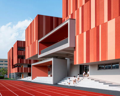 bright red striped patterns overlay fengpu elementary school's exterior in shanghai