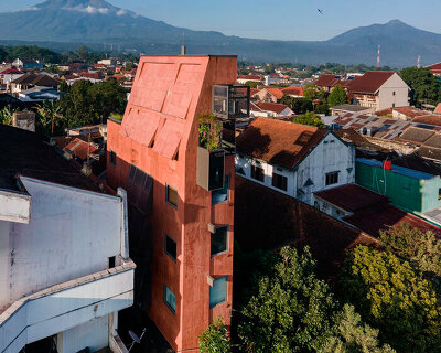 red agra sandstone coats the facades of slender PituRooms hotel in indonesia