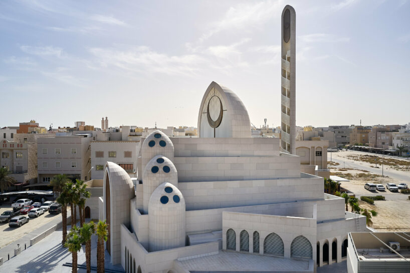 rhythmically stacked, rotating volumes and half domes compose kuwaiti mosque by babnimnim