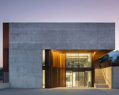 school expansion's louvered facade opens entirely toward the swiss alpine landscape