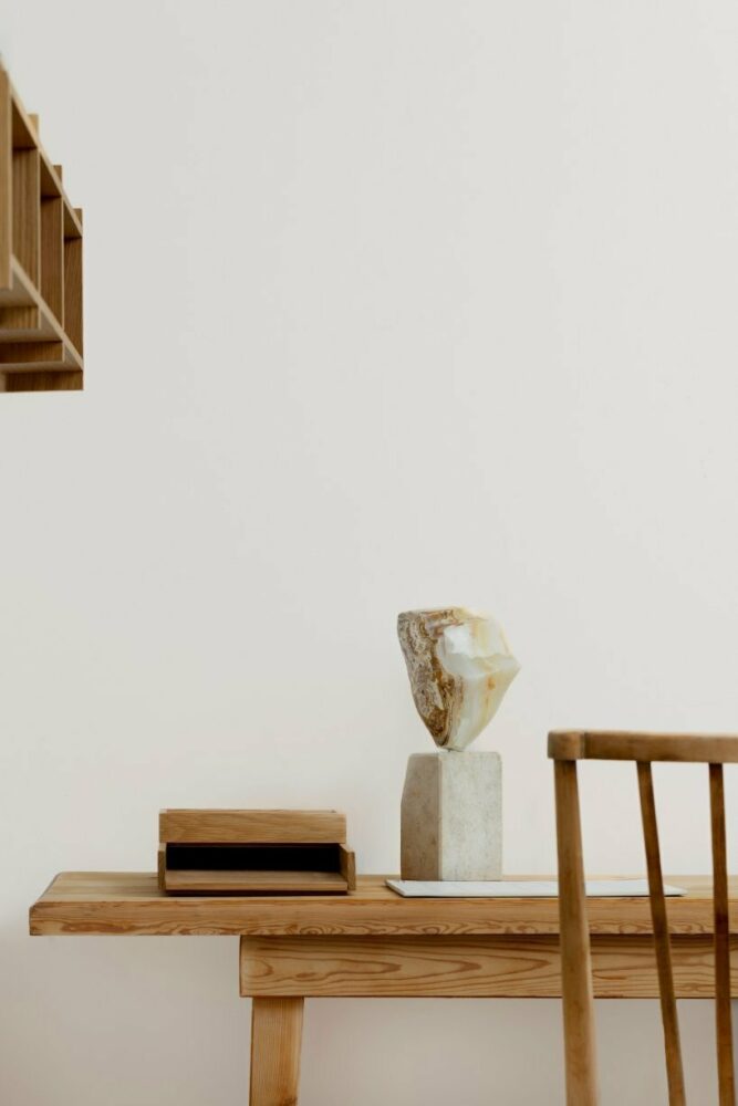 home office with a vintage desk and chair from the 1960s, and a marble figurine from childhood