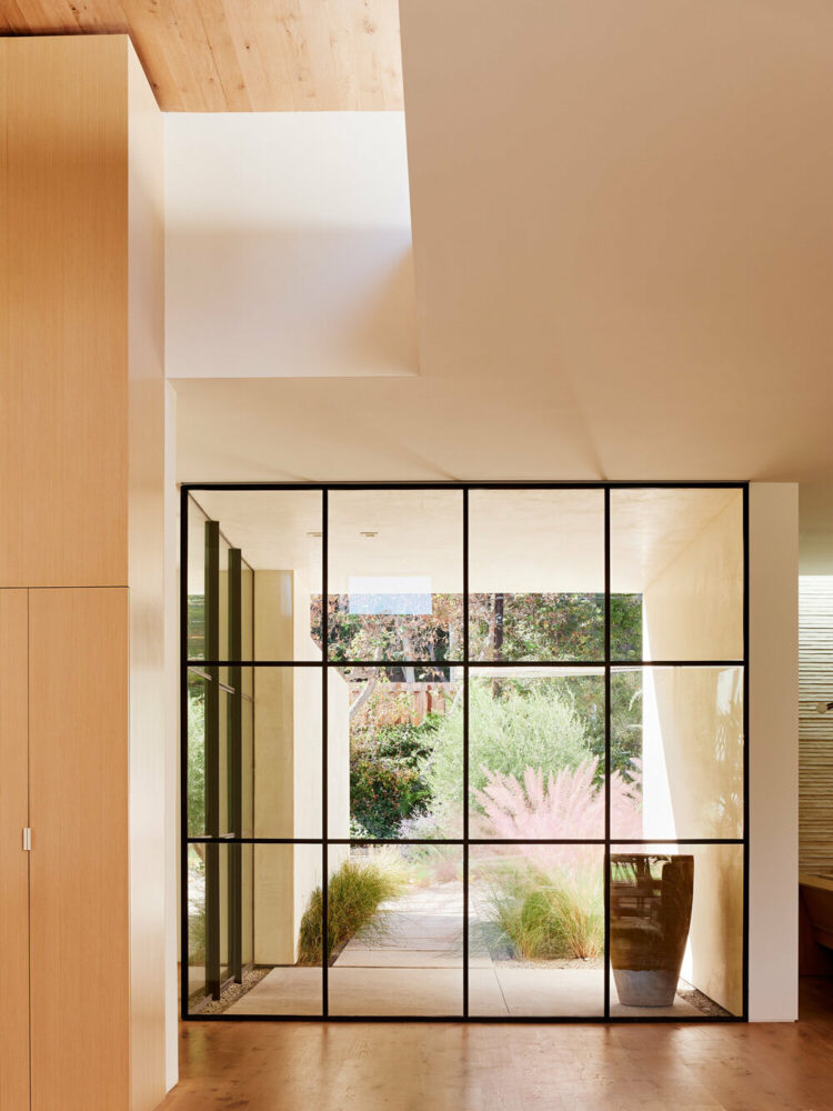 floor-to-ceiling glass walls with views to the greenery