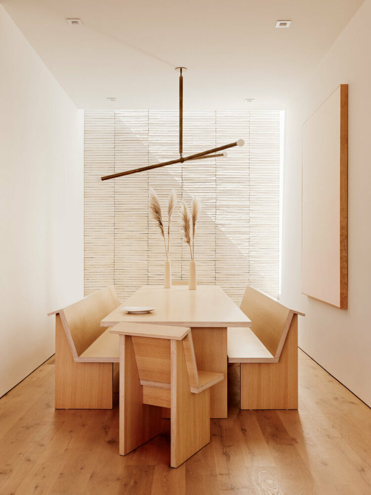oatmeal-colored brick wall with custom dining room table and chairs