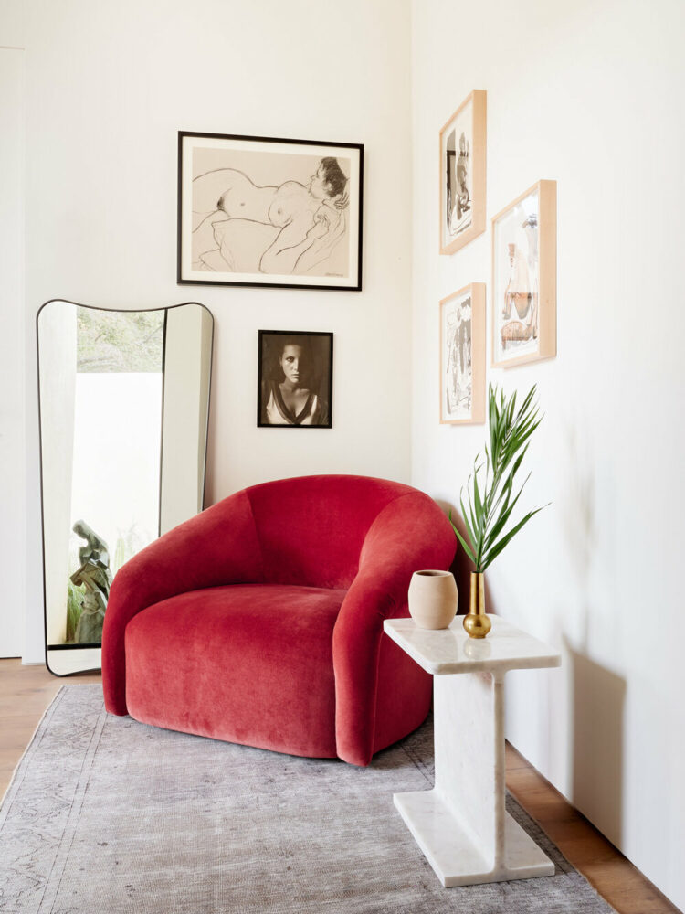 artful sitting room with deep red chair