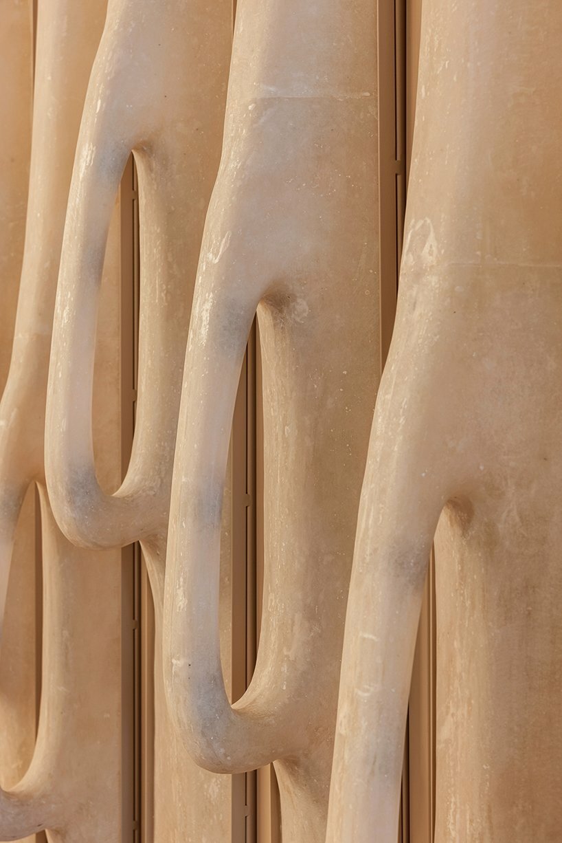 sewing machine sculpture takes center stage in dage curtain store by molos