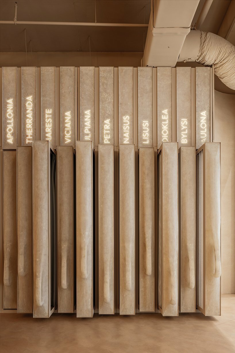 sewing machine sculpture takes center stage in dage curtain store by molos