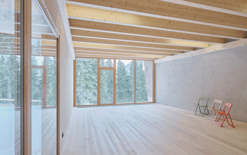 the extended section features a kitchen, living room, lounge, and a multi-purpose room with climbing wall and stage