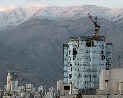 manuel alvarez diestro captures construction crane silhouettes against tehran’s cityscape