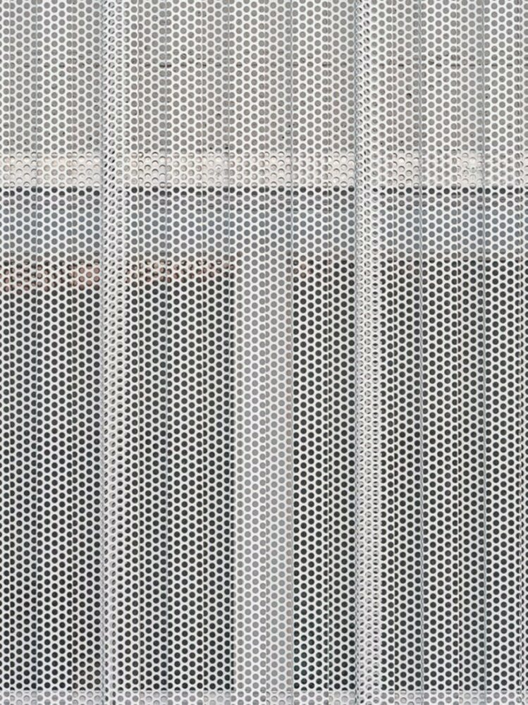 strategically designed perforated plates enhance airflow and lighting, optimizing workspace efficiency