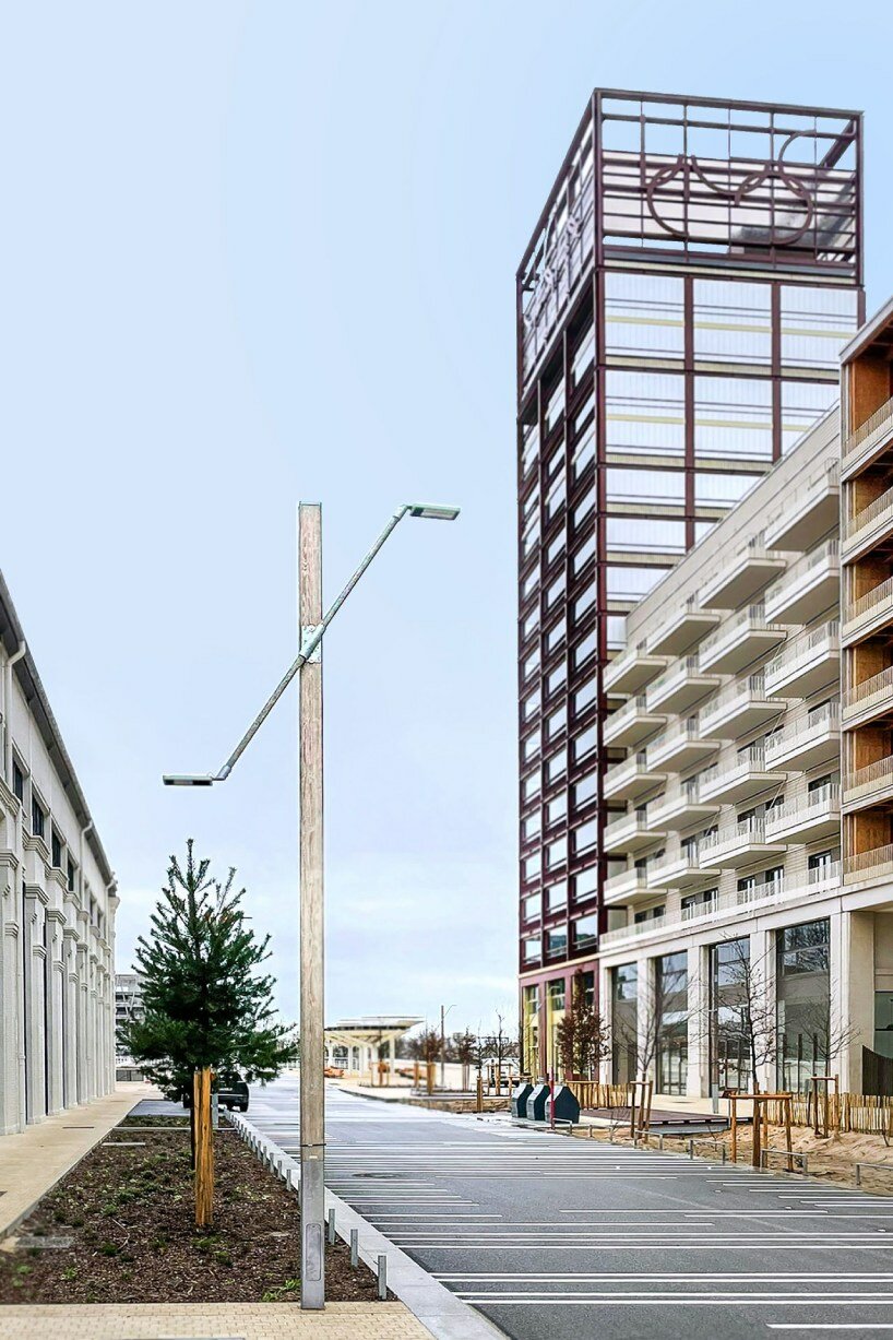 studio 5•5 repurposes old scaffolding pipes and street lamps to illuminate paris olympic village