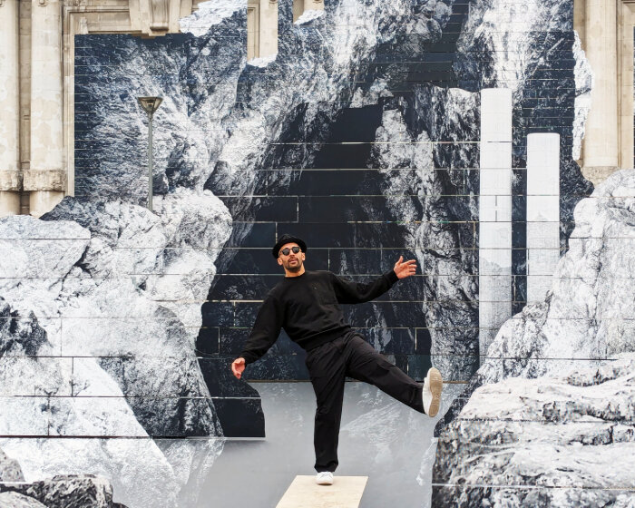 JR’s new monumental rock installation ‘la nascita’ emerges in front of milan central station