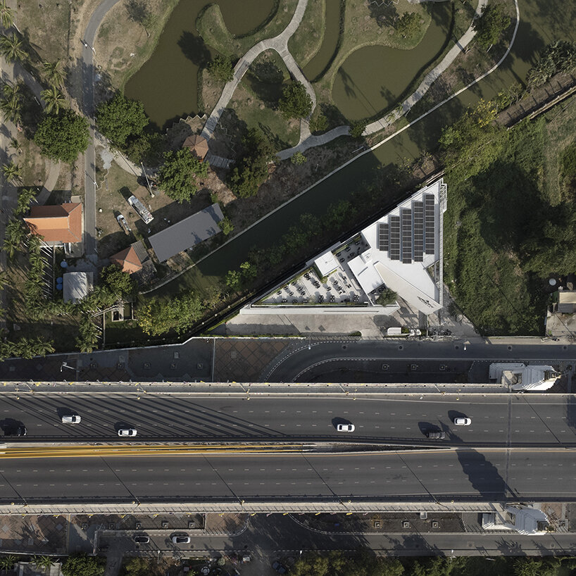 ASWA clads triangular craft estate in fiberglass semi-transparent facade in thailand