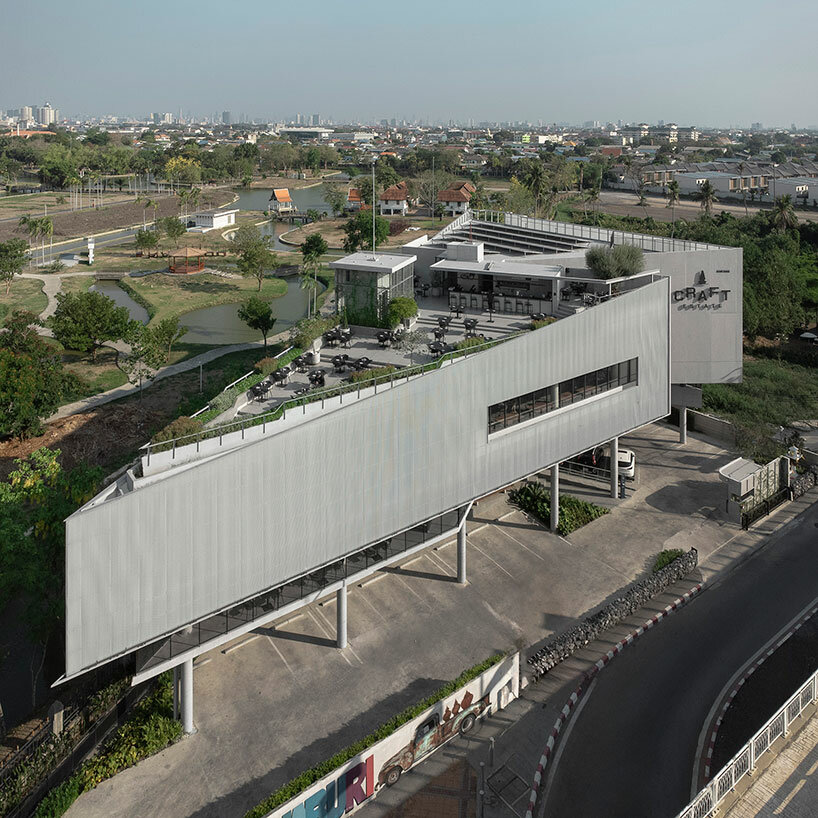 ASWA clads triangular craft estate in fiberglass semi-transparent facade in thailand