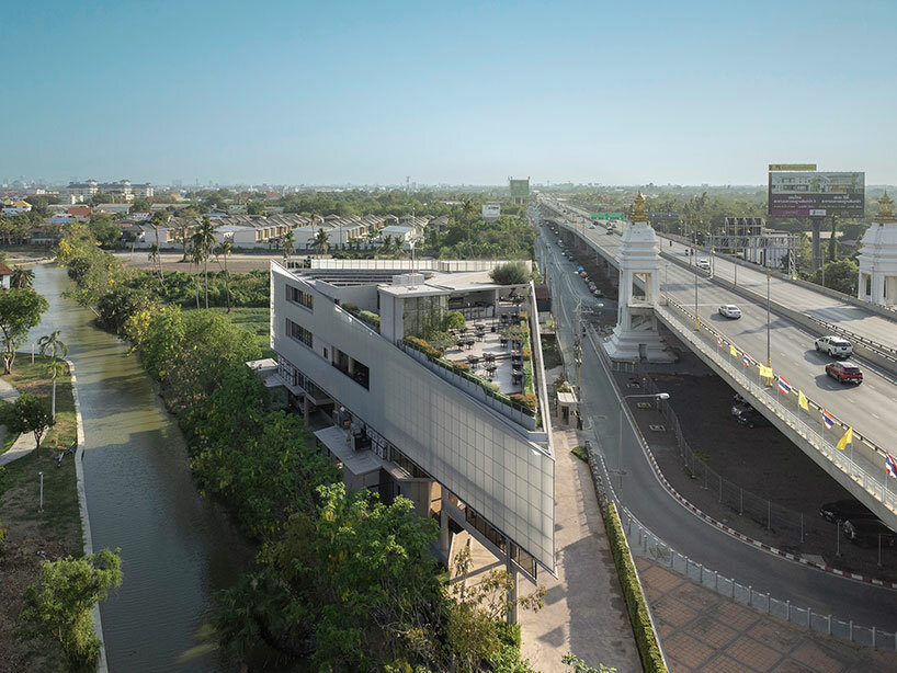 ASWA clads triangular craft estate in fiberglass semi-transparent facade in thailand