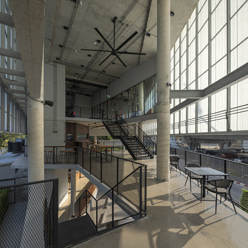 ASWA clads triangular craft estate in fiberglass semi-transparent facade in thailand