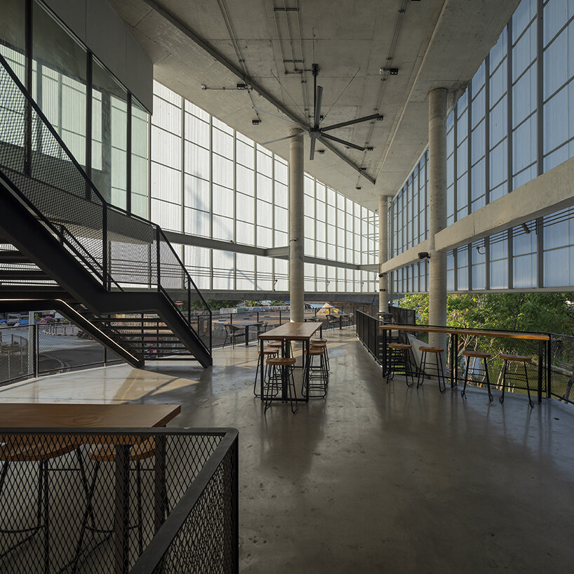 ASWA clads triangular craft estate in fiberglass semi-transparent facade in thailand