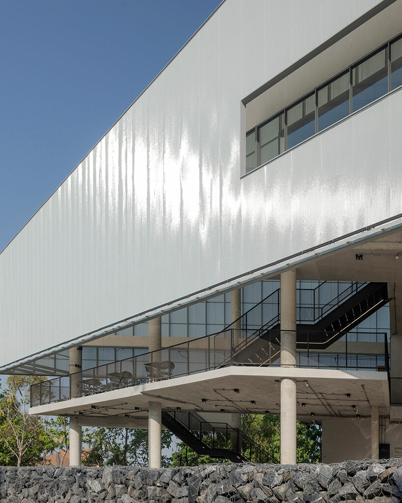 Translucent Shell Facade ASWA clads triangular craft estate in fiberglass semi-transparent ...