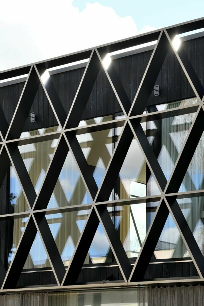 the honeycomb-like design protects the interior from sunlight and shelters the terraces