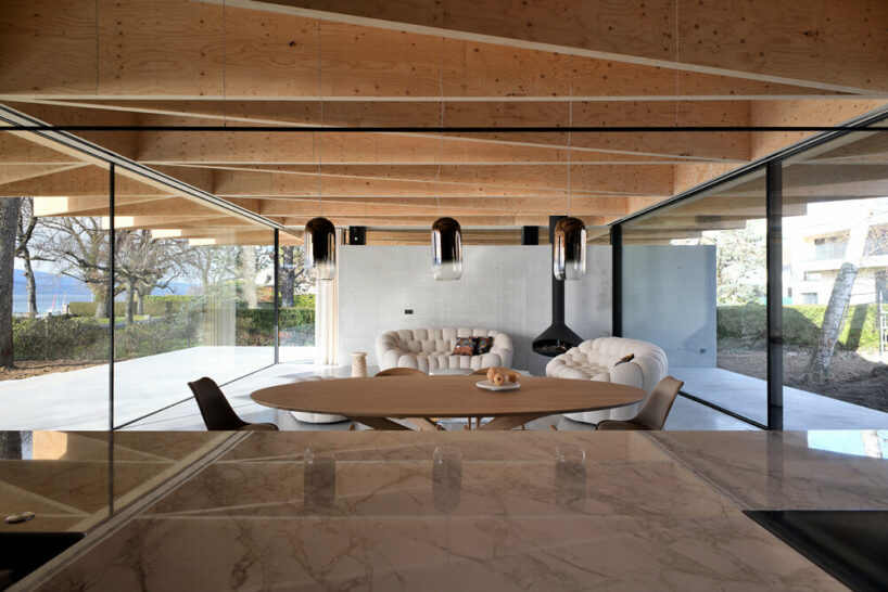 the wooden structure is not only visually intriguing but also protects the interior from sunlight