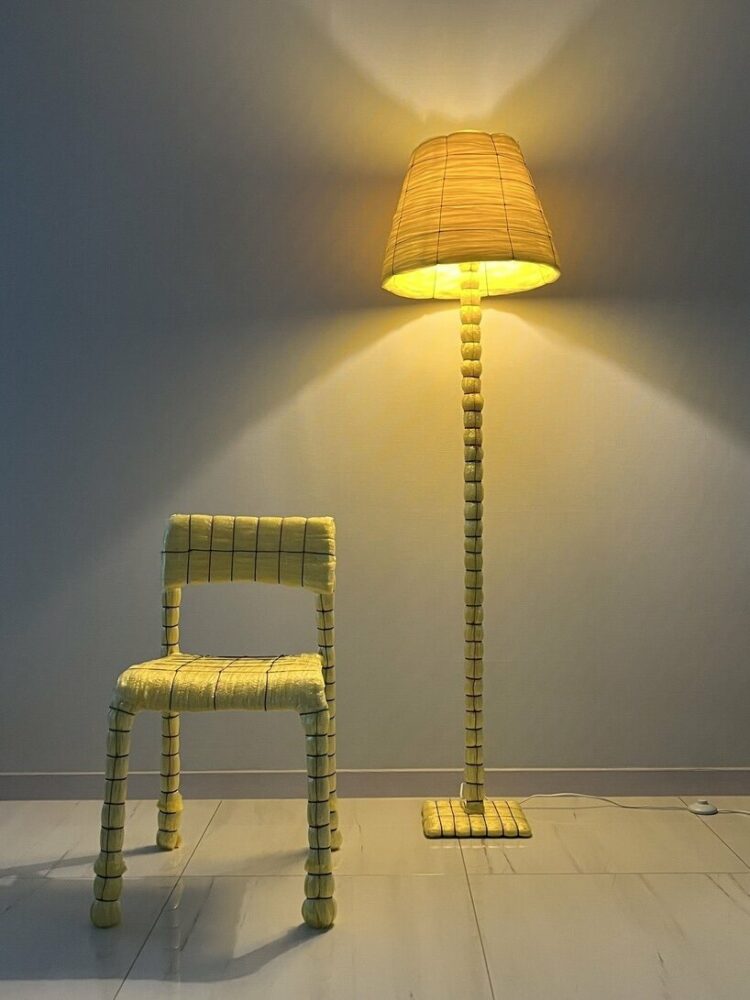 the reed broom features a chair and a floor lamp