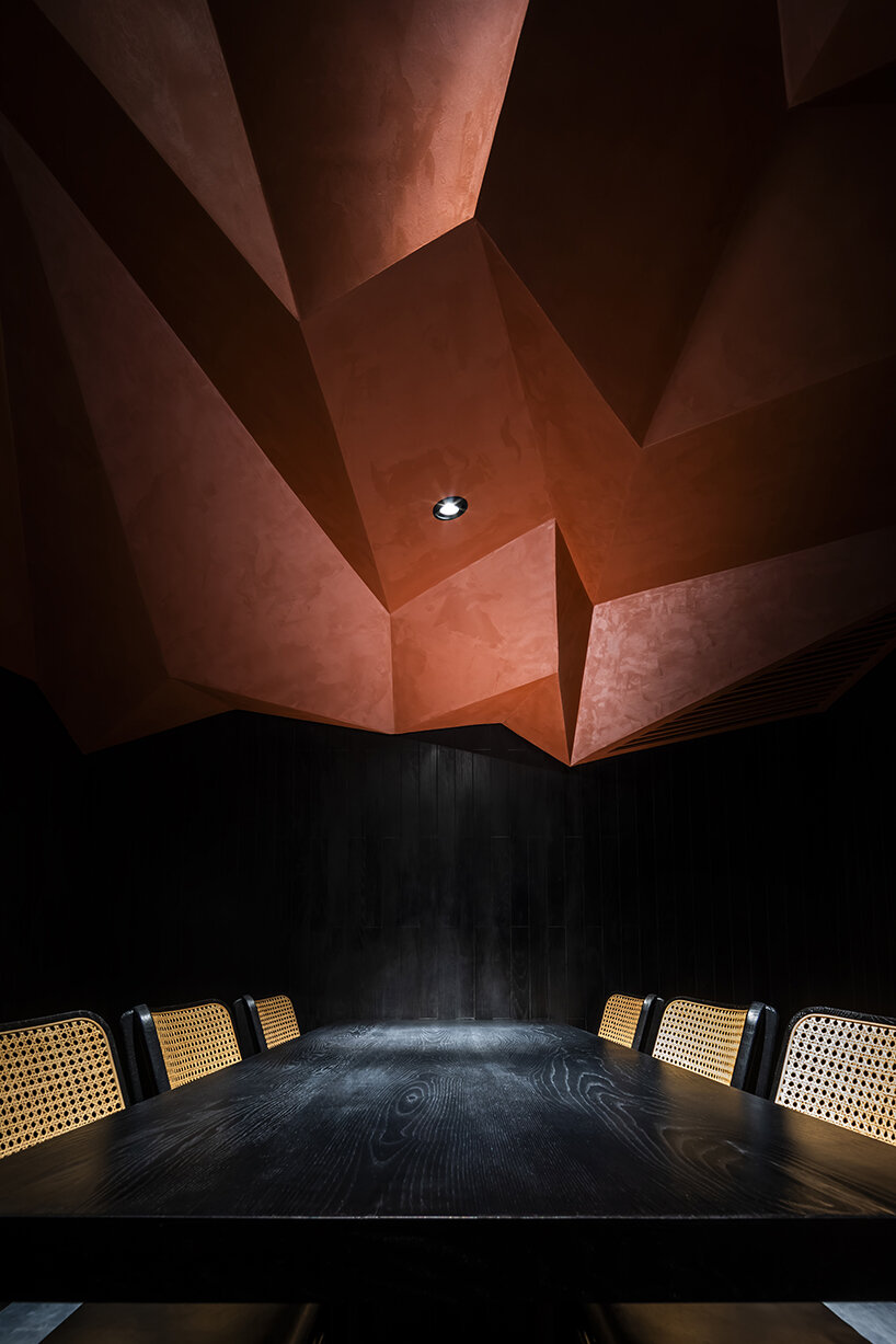 vermilion origami ceiling unfolds inside inrestudio's sushi restaurant in vietnam 