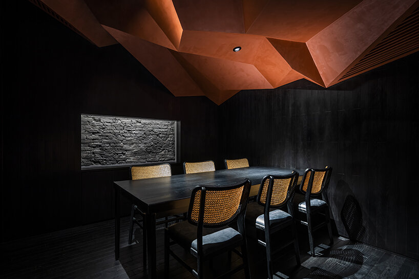 vermilion origami ceiling unfolds inside inrestudio's sushi restaurant in vietnam 