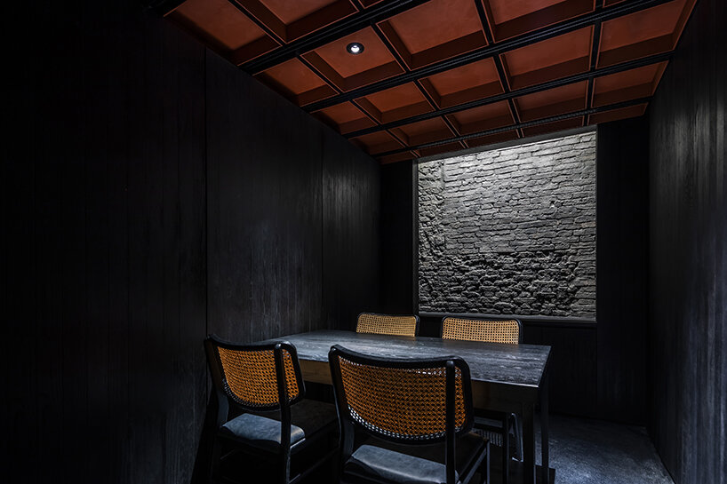 vermilion origami ceiling unfolds inside inrestudio's sushi restaurant in vietnam 