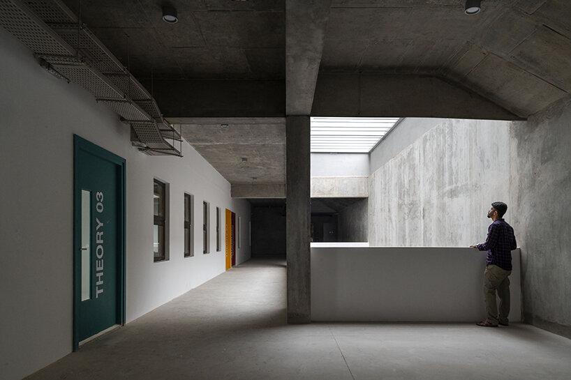 light filters down to the lowest levels, highlighting the raw concrete backdrop