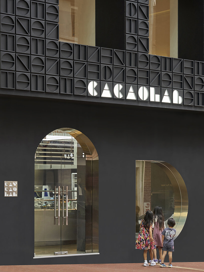 other projects' monogram facade conceals new-age cacaolab flagship store in hong kong