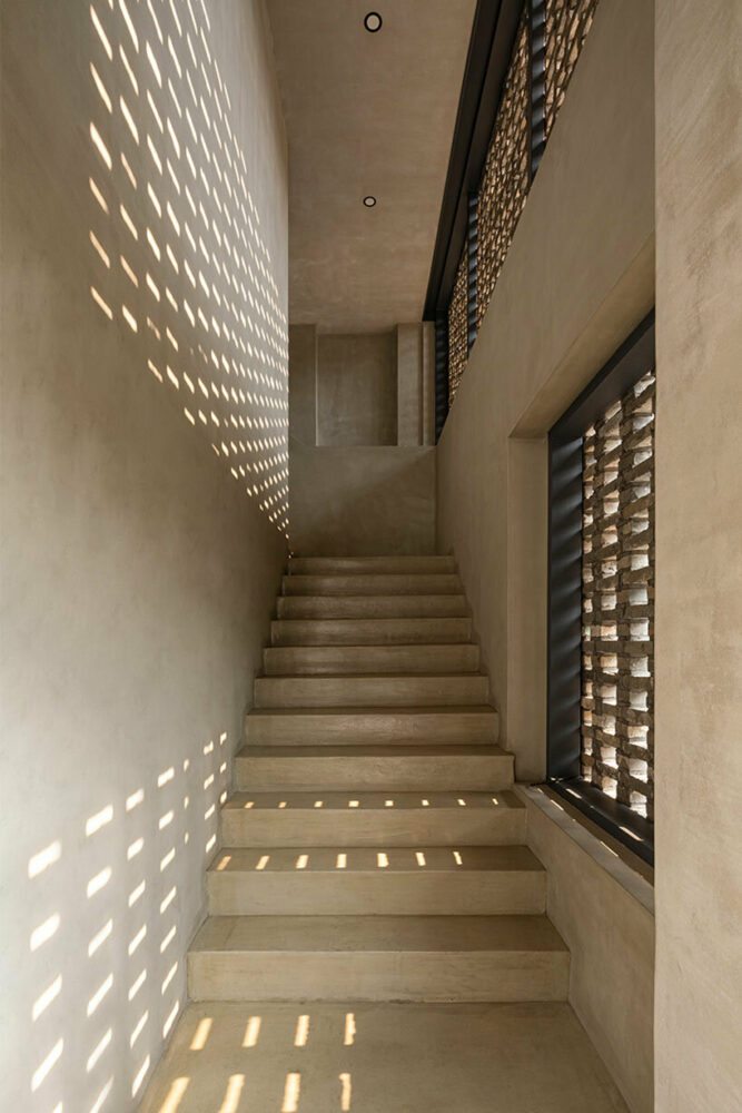 the brick facade creates shadowplay in the interior