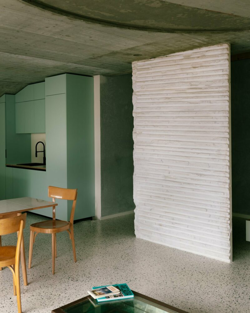 the basement apartment now features south-facing living areas with a loggia opening to the garden