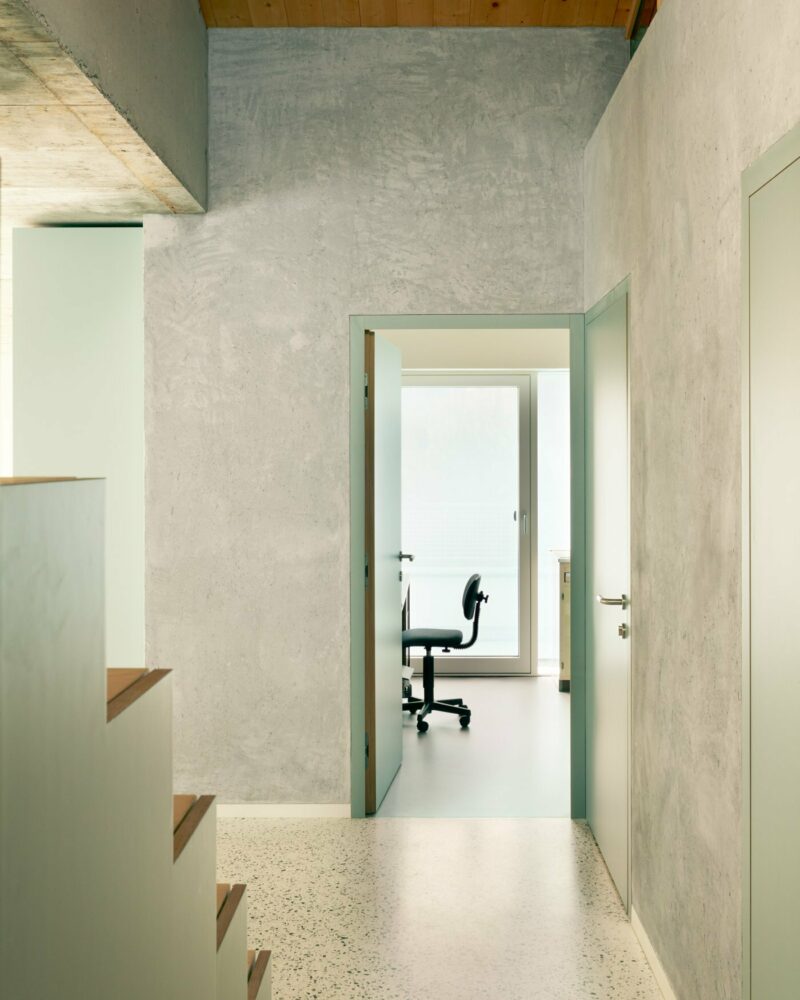 fhe second-floor apartment is accessed via the parking deck, with an interior staircase connecting to the downstairs floors