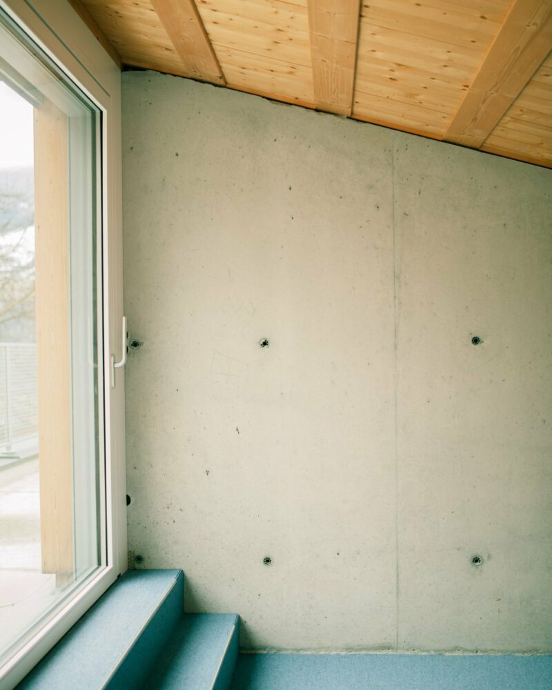 the second floor extends along a generous south-facing window, with a sheltered terrace on the west side