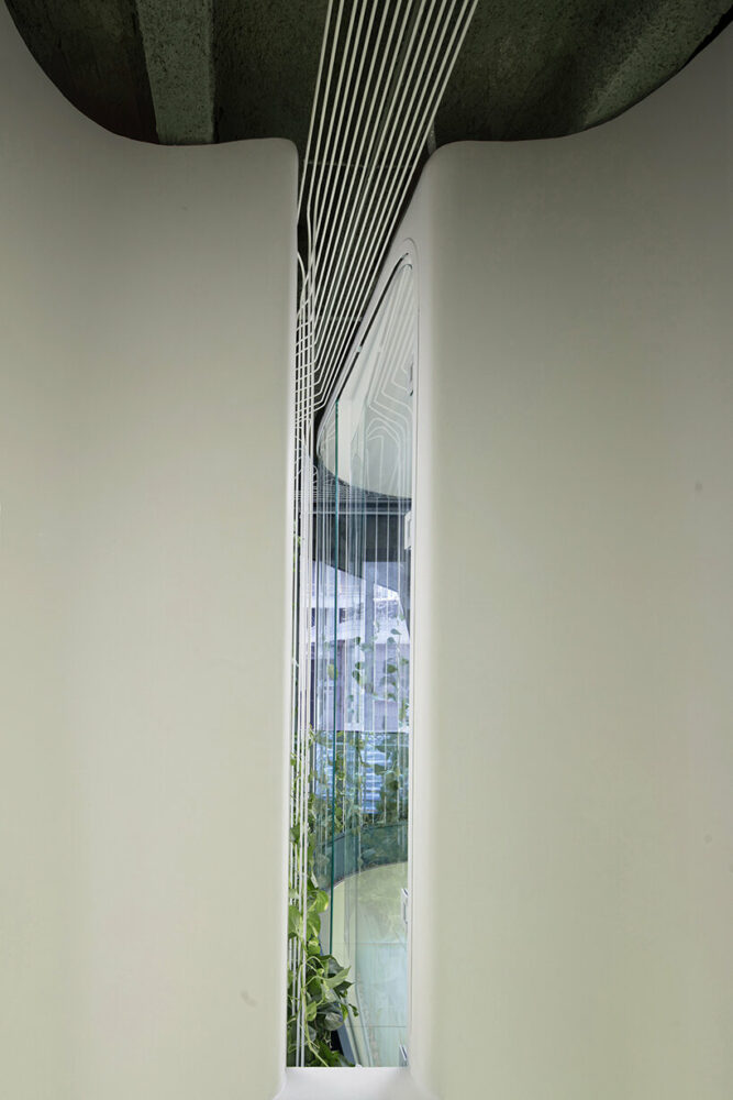 a small window at the end of the corridor allows natural light and outside views to enter the space