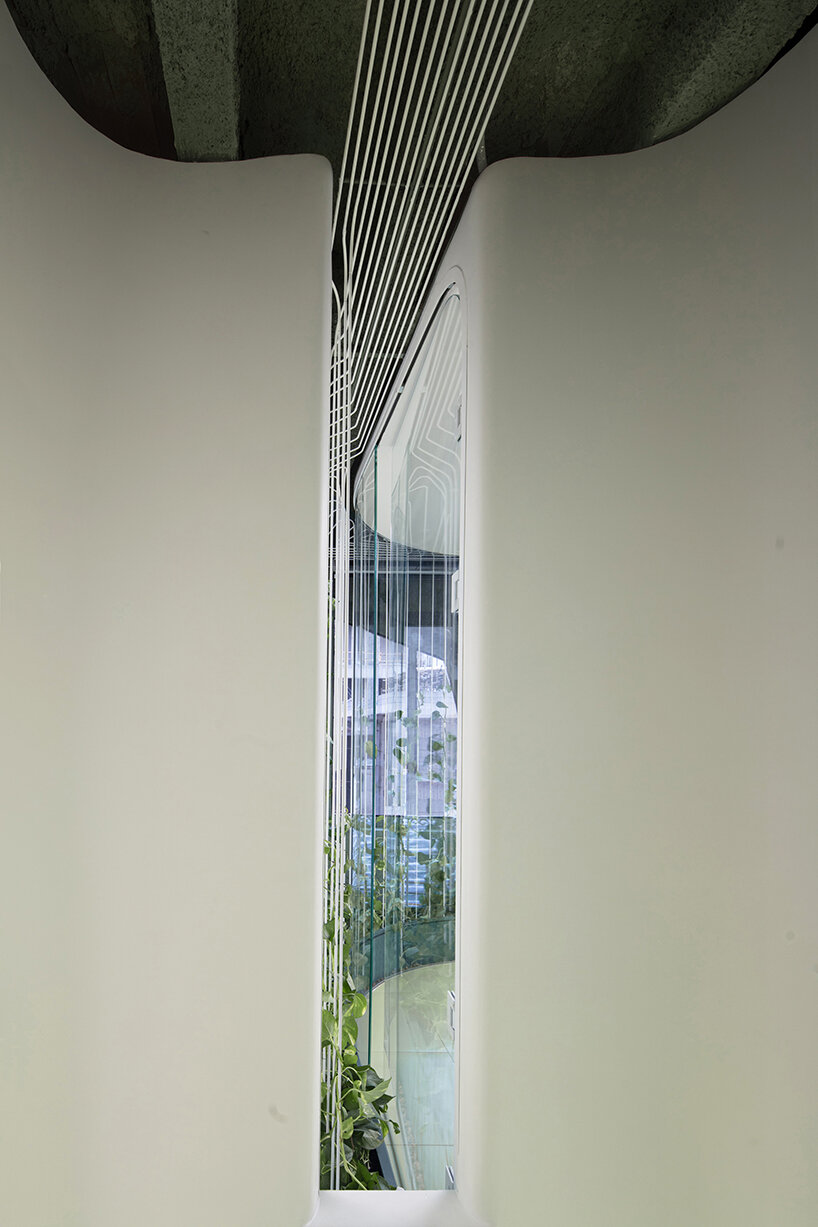 a small window at the end of the corridor allows natural light and outside views to enter the space