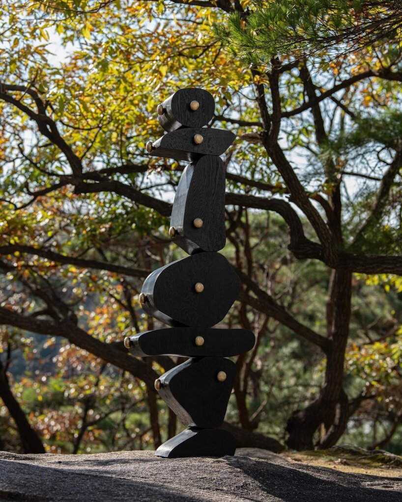 irregularly stacked volumes capture the korean tradition of wish-making in jaewoo ahn's wooden cabinet