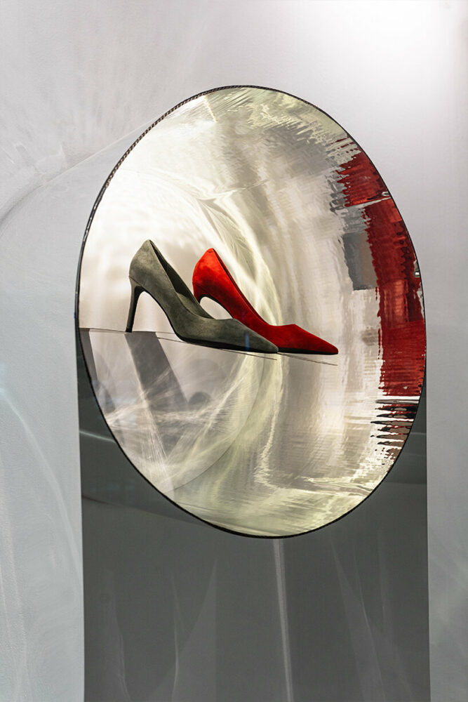 mirror circles on the glass reflect viewers and incorporate the external environment