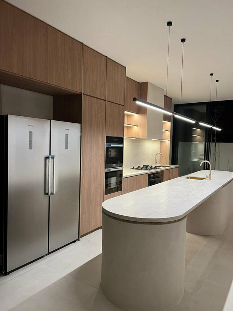 the kitchen features a robust island counter bench