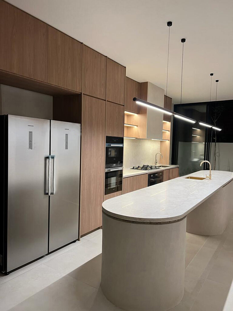 the kitchen features a robust island counter bench