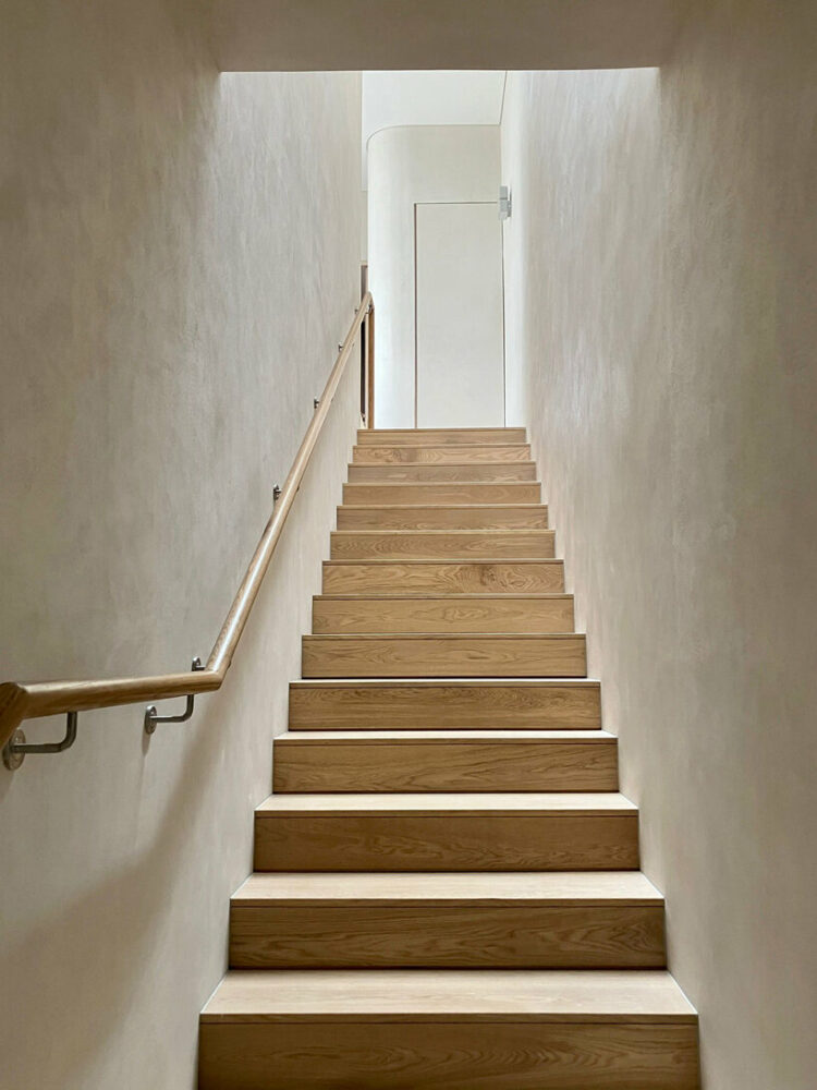 timber-clad staircase and handrail with integrated lighting detail