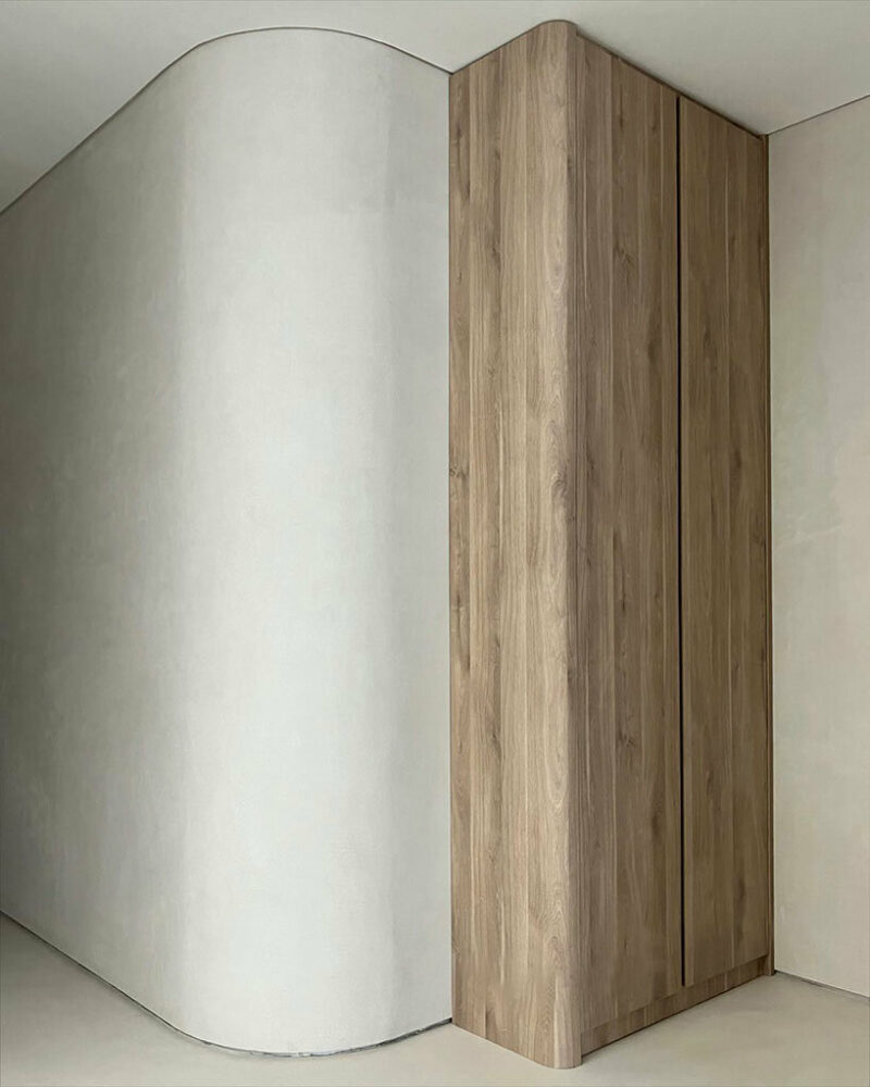 the material palette features oak timber, brushed metal, bush-hammered granite, and honed marble