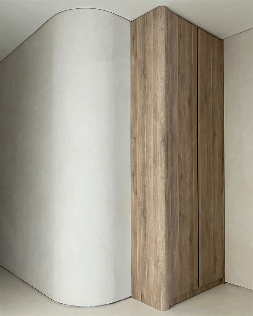 the material palette features oak timber, brushed metal, bush-hammered granite, and honed marble